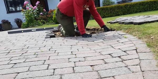 block paved patio job - image shows one of the team laying a block paved patio